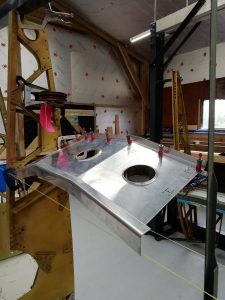 In the main workshop, Murphy has been continuing his fabrication on nose rib 10 for the port wing. Once finished he will then be starting fabrication of the same rib for the starboard wing.  While now in the wing-shed, focus has now shifted back towards the root of the wing and in particular the wheel well area. While awaiting some more information to help correctly fabricate centre rib 8, I have focused my attention into fabricating the auxiliary spar that joins rib 5 and 8 together aft of the main undercarriage bay.  While it may appear relatively simple at first on the 2D drawing, you soon realise that not only is it mounted on an angle within the wing, it has various folds at differing angles, and comprised of 4 individual components.  The angles for example are shaped in 3 different planes, causing the material to be bent into ways that it doesn’t want to go. Using everyone’s knowledge from across the team and Laurent in particular has ensured that we have now been able to fabricate the bulk of the whole item, with only the simpler components remaining before moving onto the next stage.  All Images © Parnall Aircraft Company Ltd